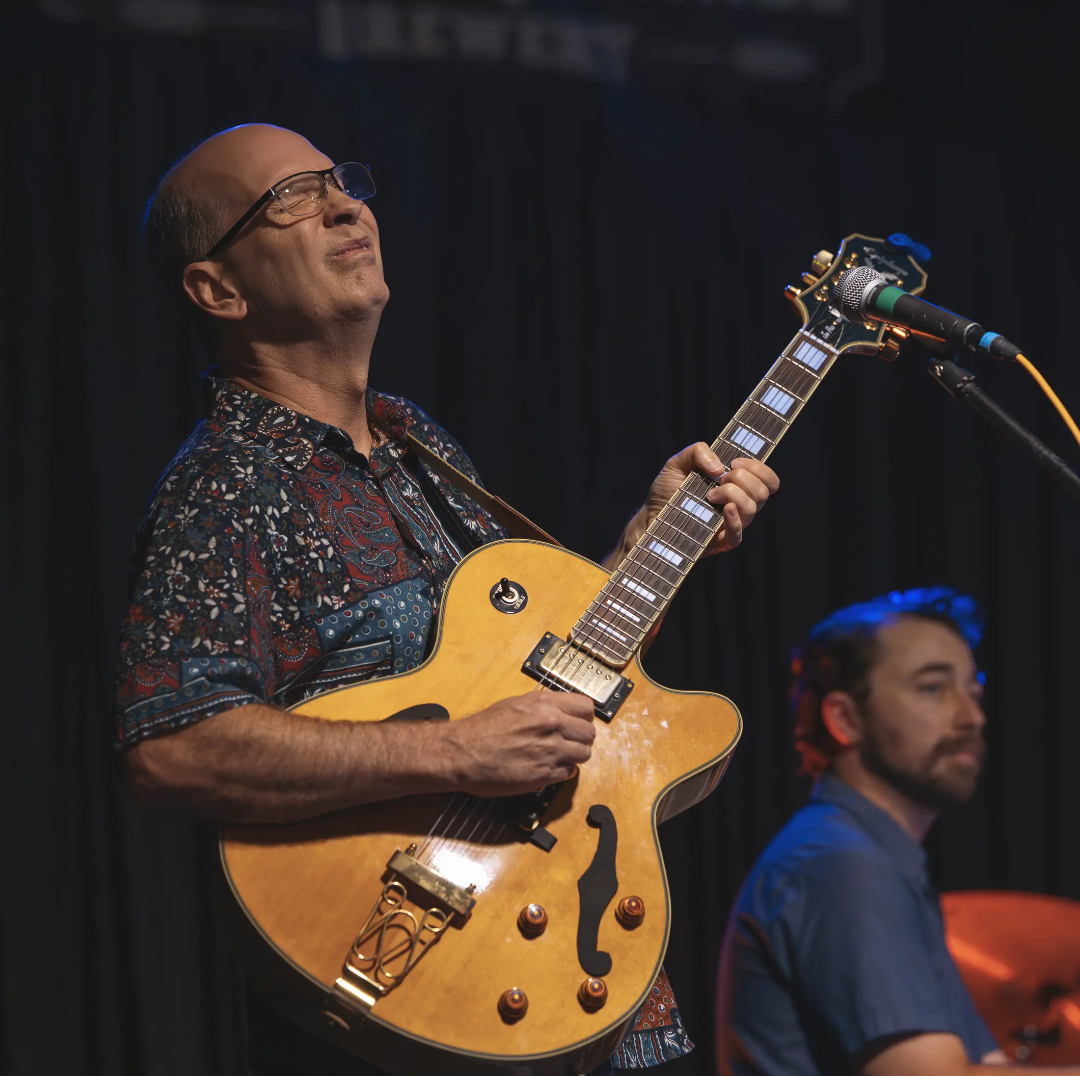 A guitarist performing on the White Squirrel stage