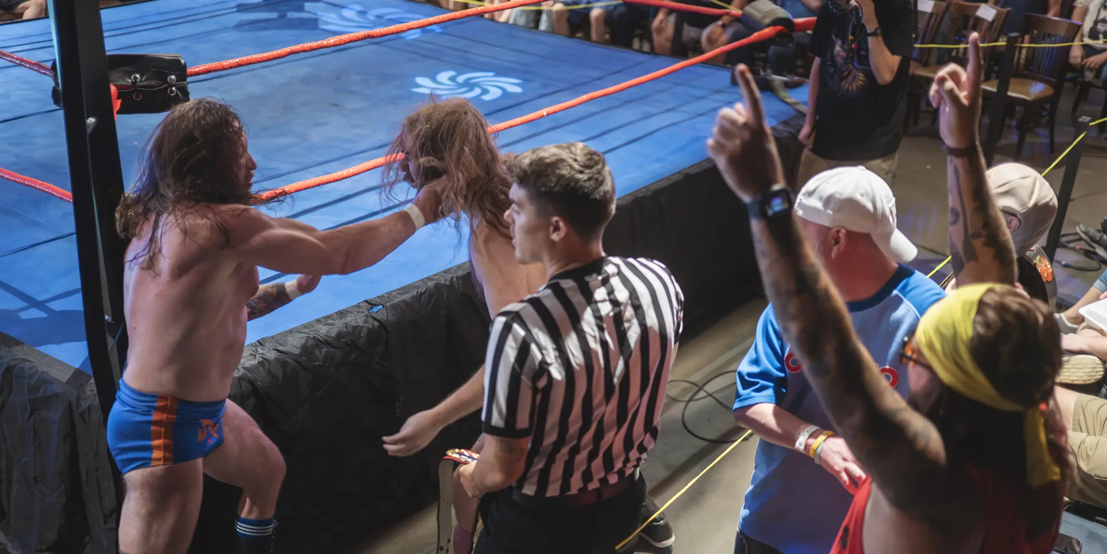 Guests cheering beside the wrestling ring at White Squirrel